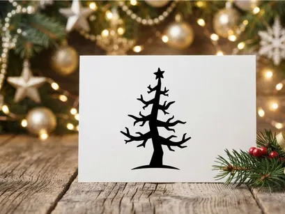 Black silhouette of a stylized Christmas tree with a star topper on white background