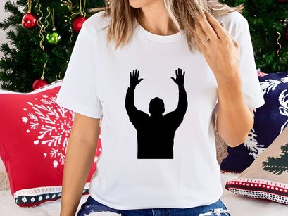 A silhouette of a man with his hands raised up in the air in celebration or triumph