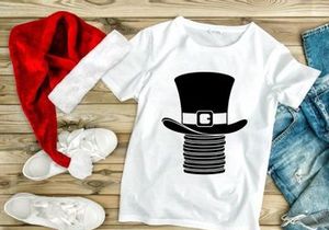 Black top hat with gold clasp on stacked coins isolated