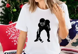 American football player in ready position with ball