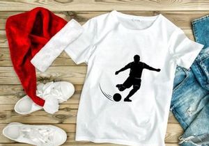 Soccer player kicking a ball in motion silhouette