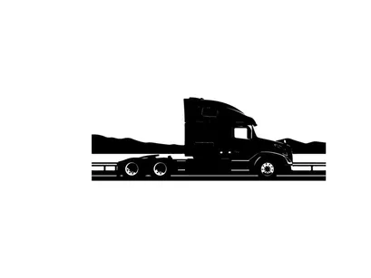 Silhouette of a semi truck driving on a highway with mountains