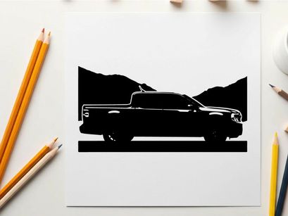 Silhouette of a pickup truck against a mountain range silhouette