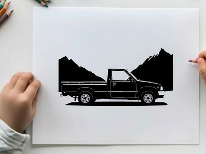 Silhouette of a pickup truck in front of mountains