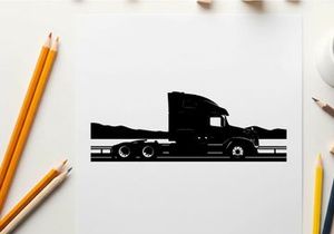 Silhouette of a semi truck driving on a highway with mountains