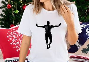 A black silhouette of a referee with arms outstretched in a sports setting