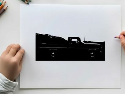 Silhouette of a classic pickup truck in front of a mountain range silhouette